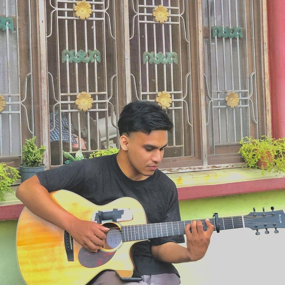 Pratik playing guitar at home